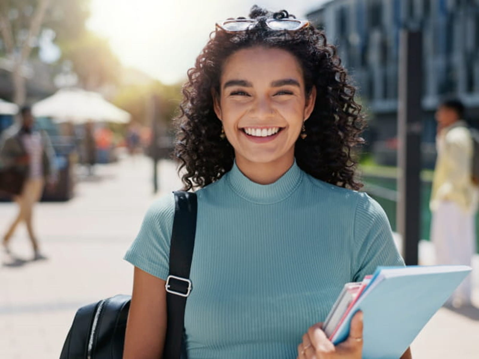 Girl smiling holding books