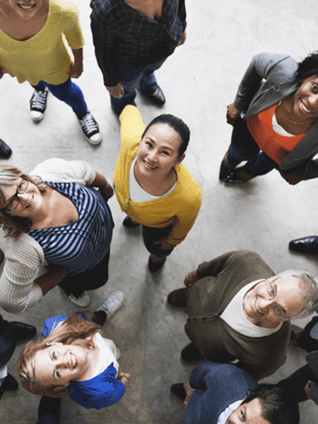 Diverse group of people smiling and looking up