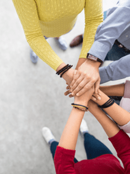 Group of people holding hands 